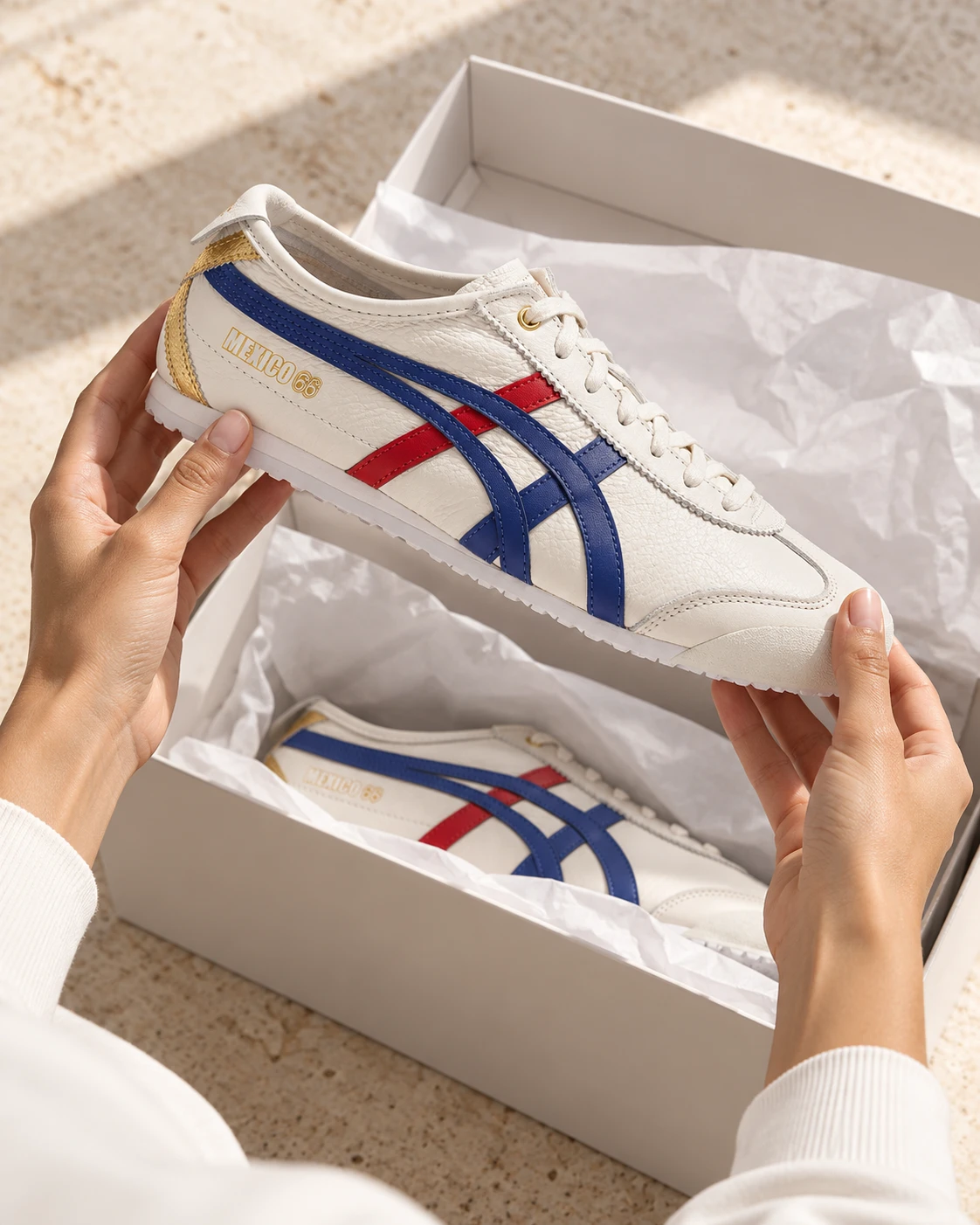 Hands lifting a sneaker out of its box in soft daylight